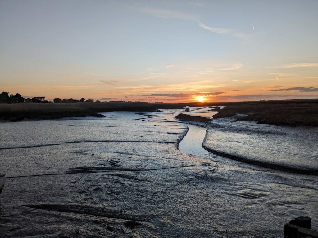 sunset over a saltmarsh creek