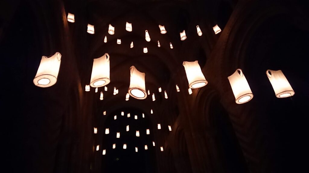 Set of lights made from miners vests against a dark background