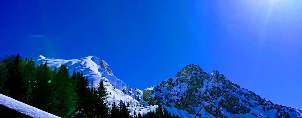 Clear blue sky and snow covered mountains